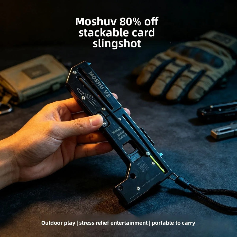 Folding card slingshot shown in the hand, open and ready to shoot