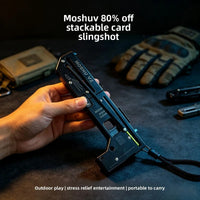 Folding card slingshot shown in the hand, open and ready to shoot