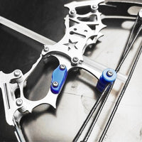 Macro detail of the stainless steel riser, cams and cables on the mini crossbow set